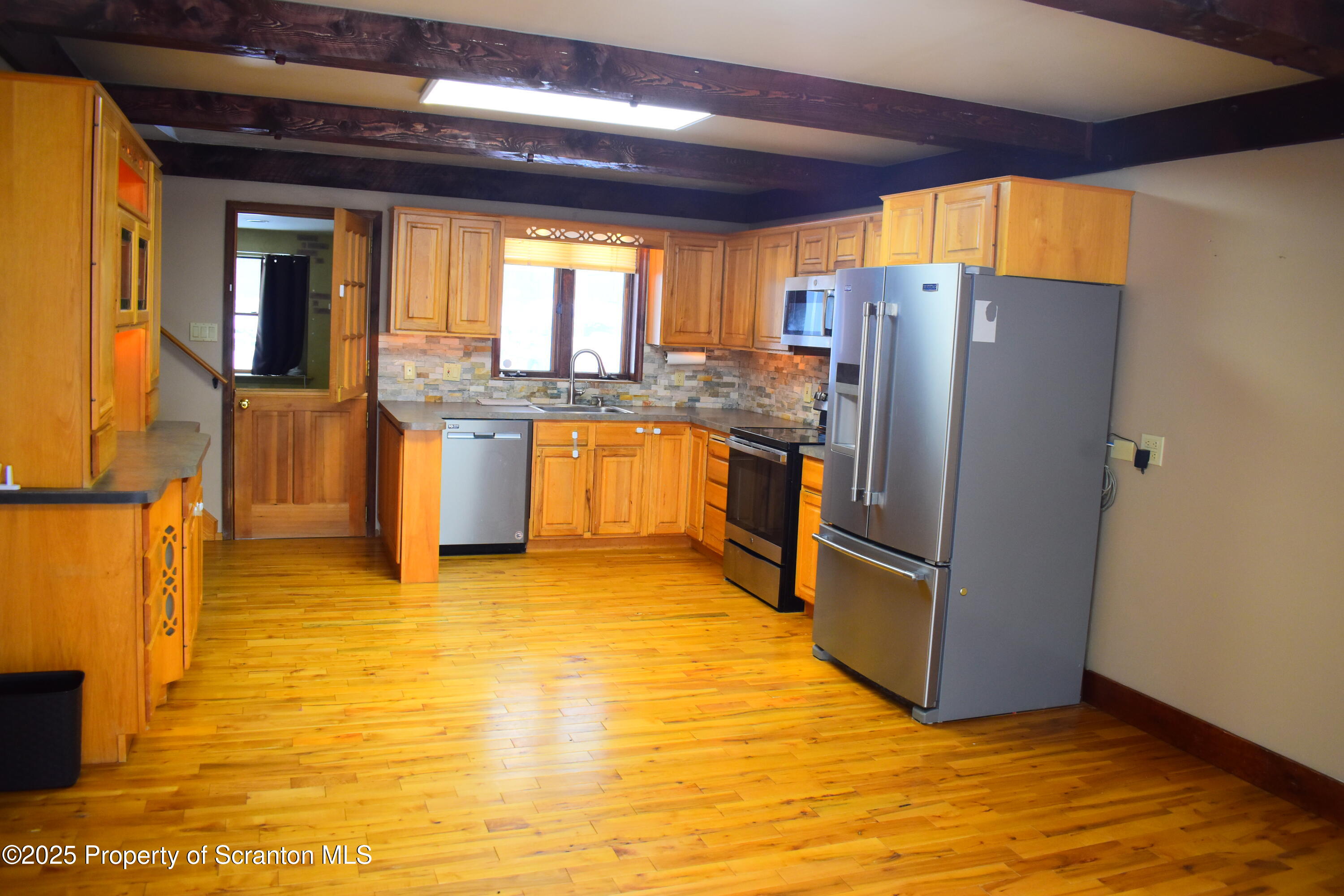 3003 Ridge Road Thompson, PA 18465 - Photo 6 of 33 a kitchen with stainless steel appliances granite countertop a refrigerator a sink and a stove
