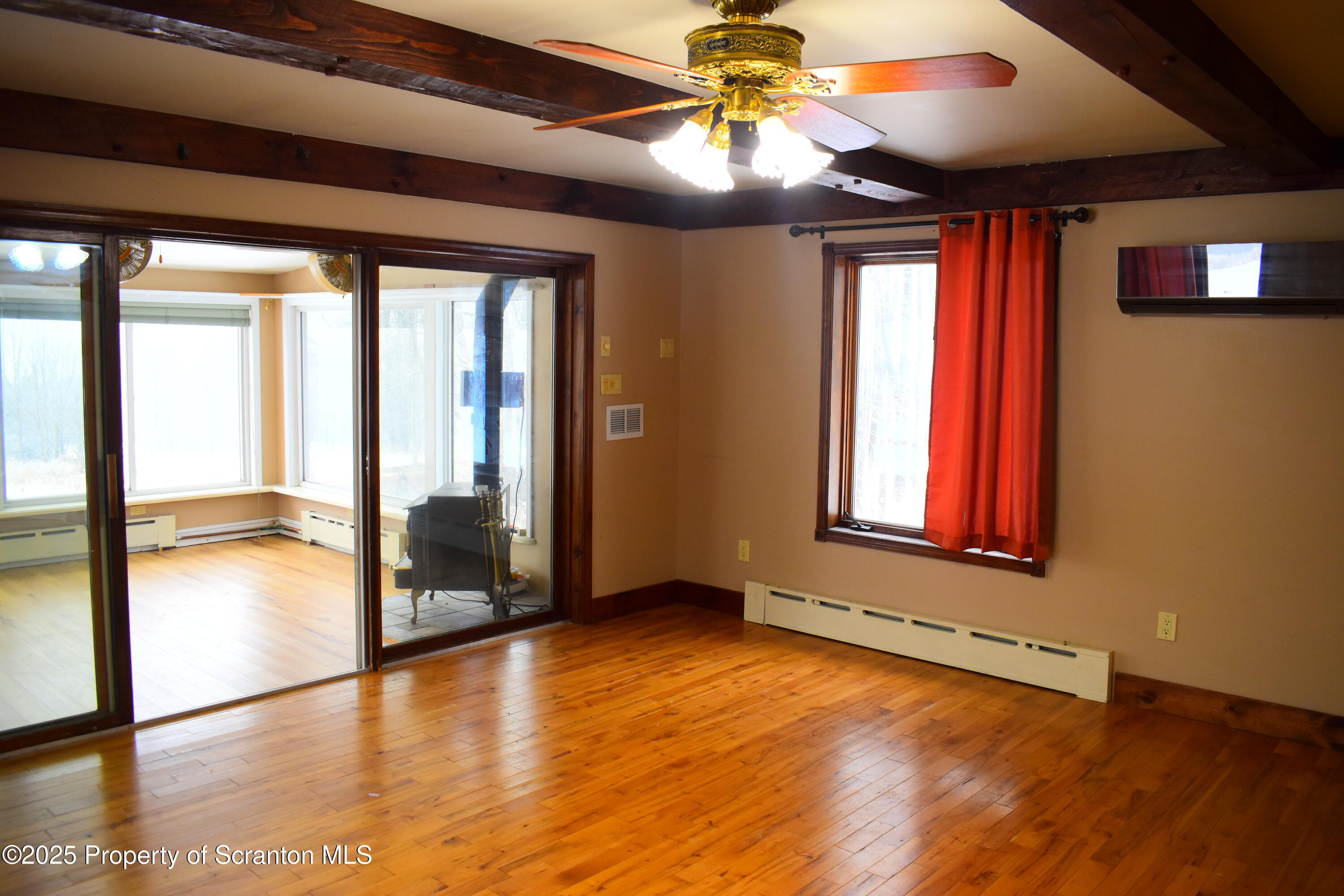 3003 Ridge Road Thompson, PA 18465 - Photo 9 of 33 a view of an empty room with window and wooden floor