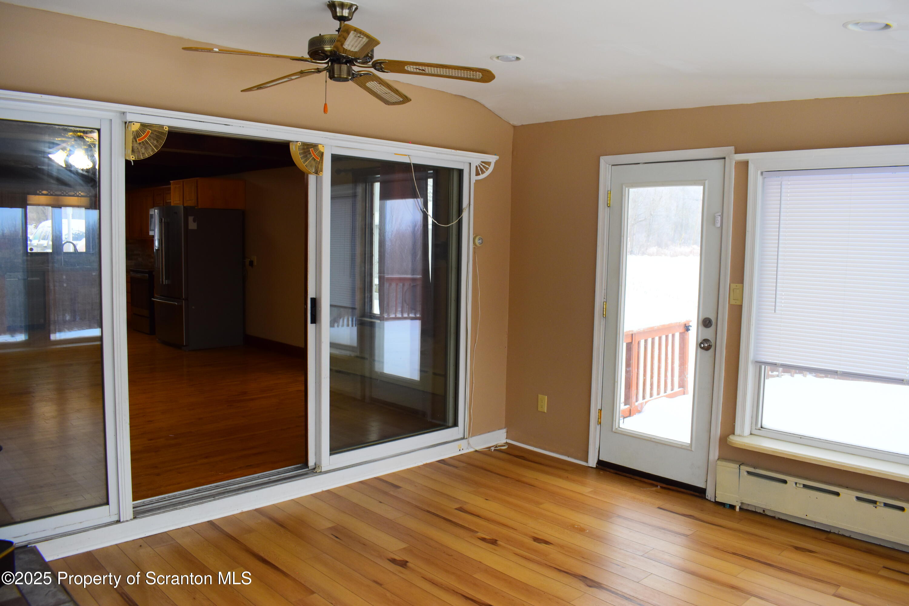 3003 Ridge Road Thompson, PA 18465 - Photo 10 of 33 a view of a hallway with wooden floor and a livingroom