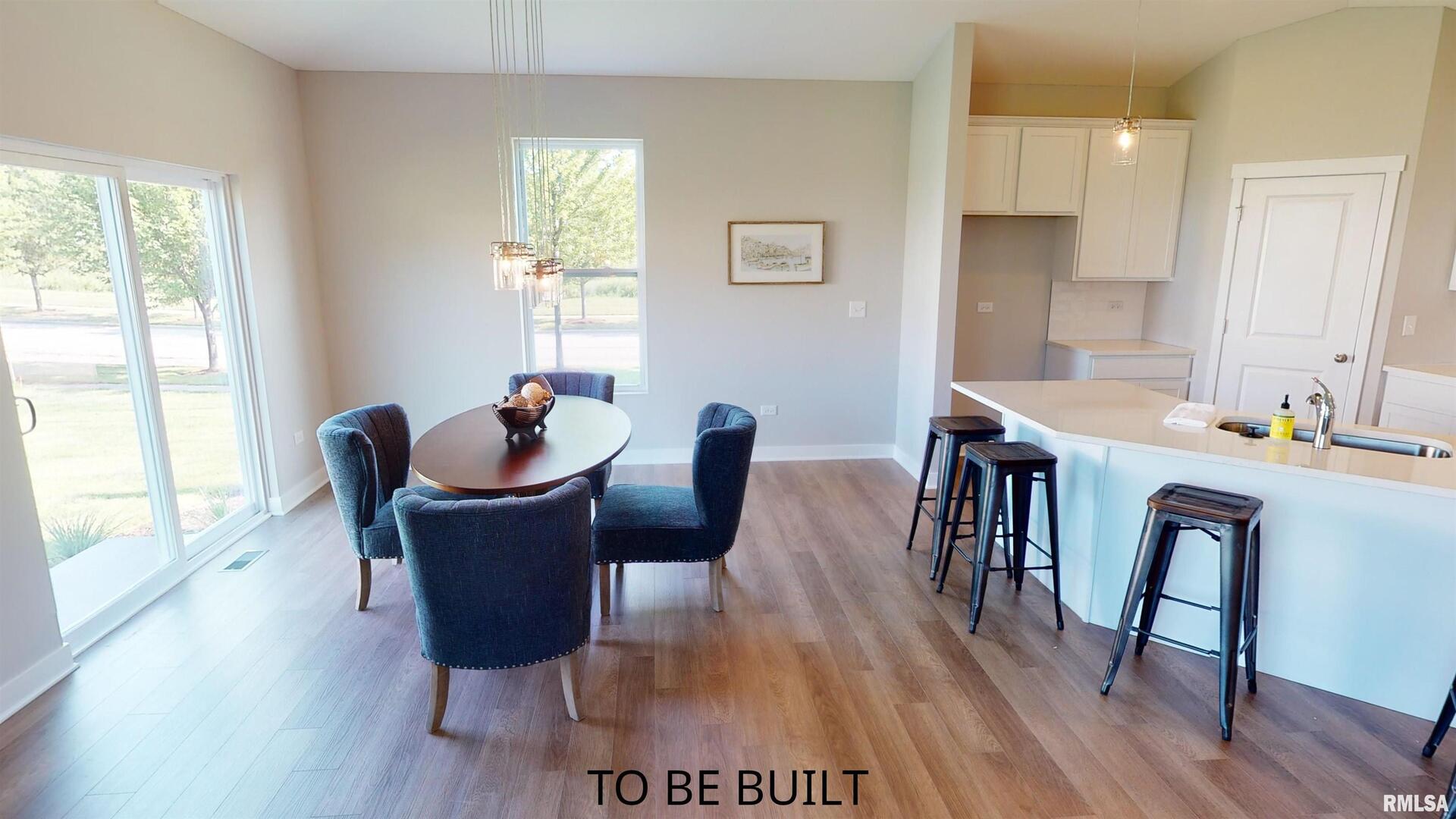7 South 5th Street Eldridge, IA 52748 - Photo 11 of 23 a dining room with furniture window wooden floor