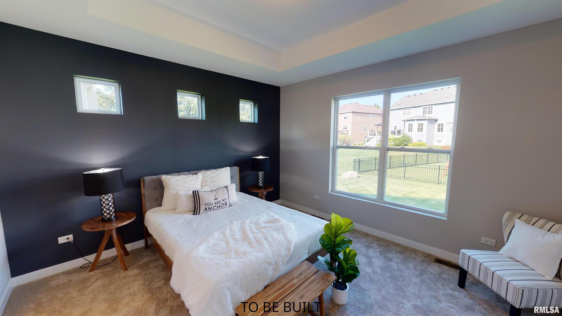 7 South 5th Street Eldridge, IA 52748 - Photo 19 of 23 a bed sitting in a bedroom next to a window