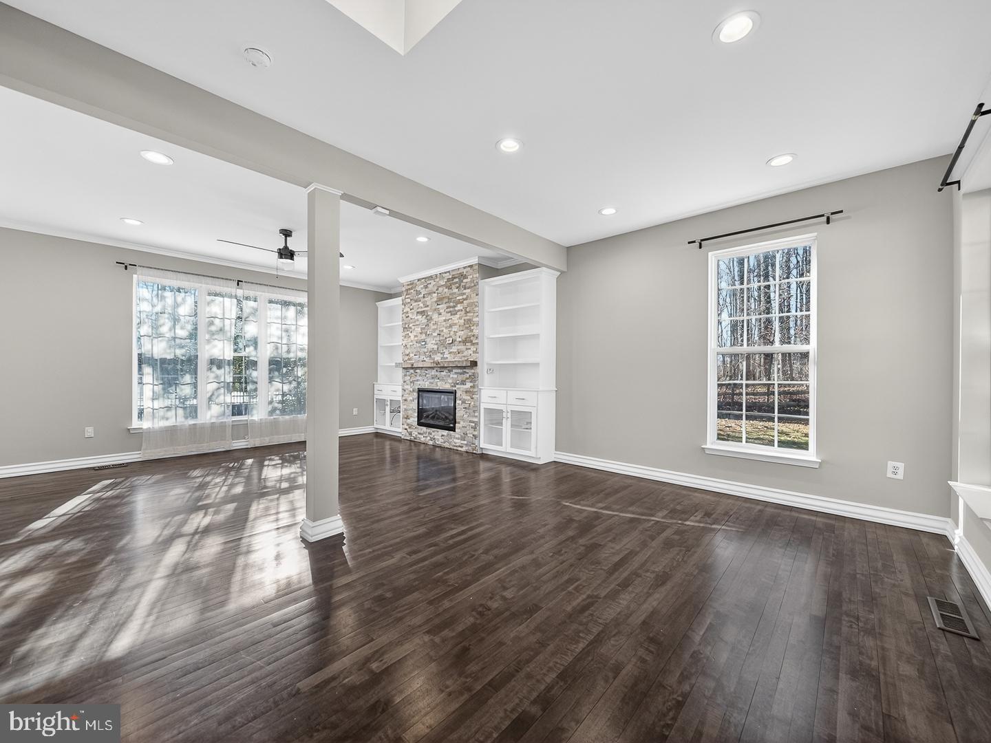 9534 Fernwood Road Bethesda, MD 20817 - Photo 12 of 44 a view of an empty room with wooden floor and a window