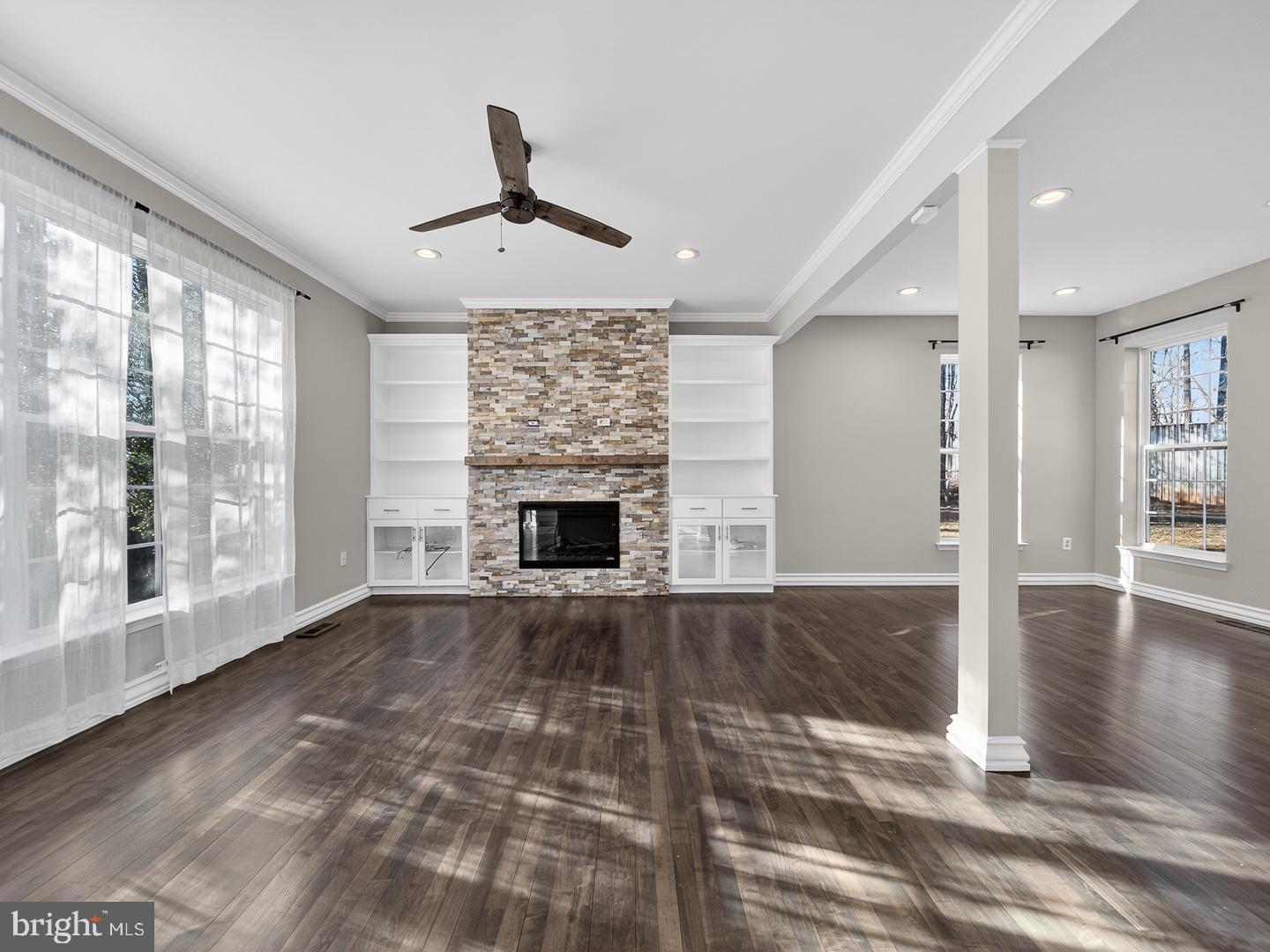 9534 Fernwood Road Bethesda, MD 20817 - Photo 13 of 44 an empty room with wooden floor fireplace and windows