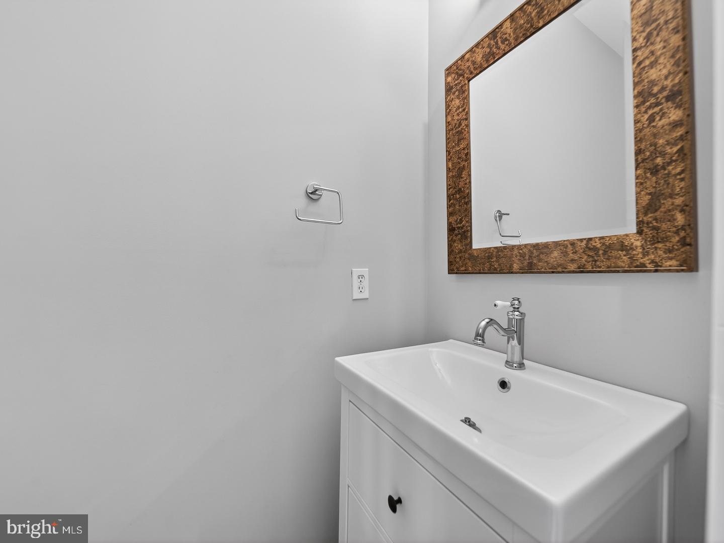 9534 Fernwood Road Bethesda, MD 20817 - Photo 16 of 44 a bathroom with a sink and a mirror