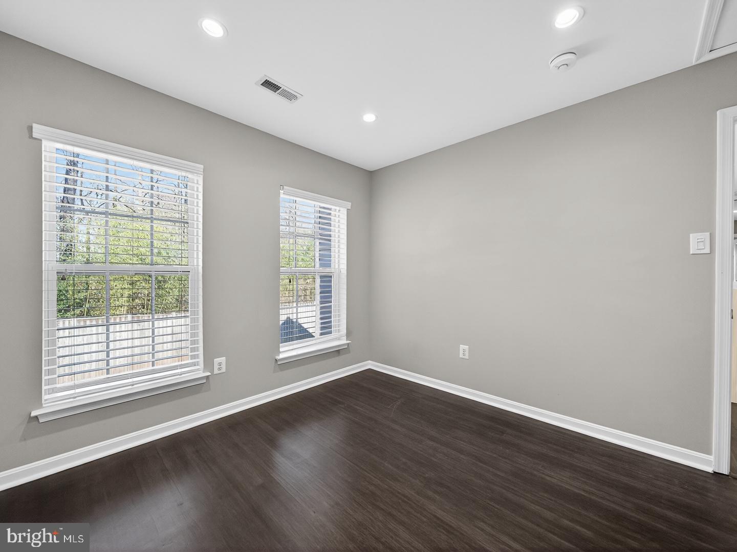 9534 Fernwood Road Bethesda, MD 20817 - Photo 19 of 44 a view of empty room with wooden floor and fan