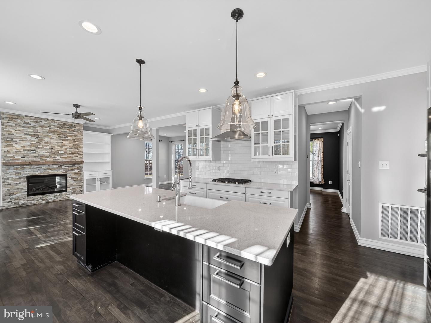 9534 Fernwood Road Bethesda, MD 20817 - Photo 2 of 44 a large kitchen with kitchen island a island a stove a sink a center island and wooden floor