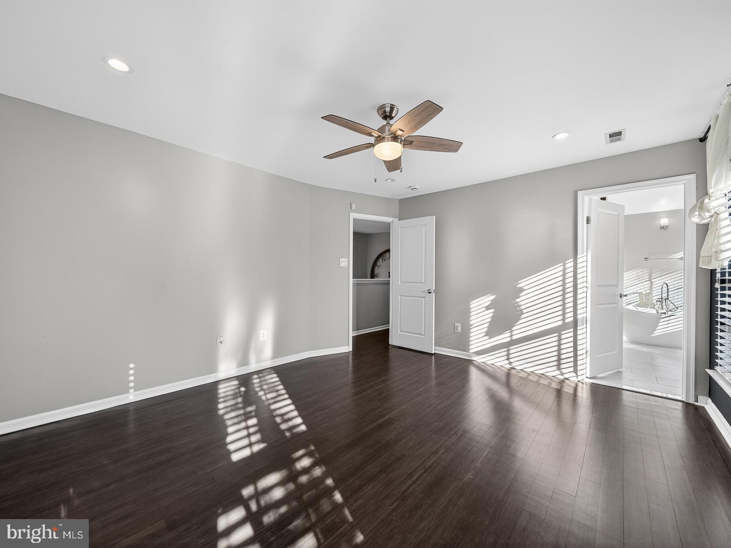 9534 Fernwood Road Bethesda, MD 20817 - Photo 21 of 44 a view of an empty room with wooden floor and a window