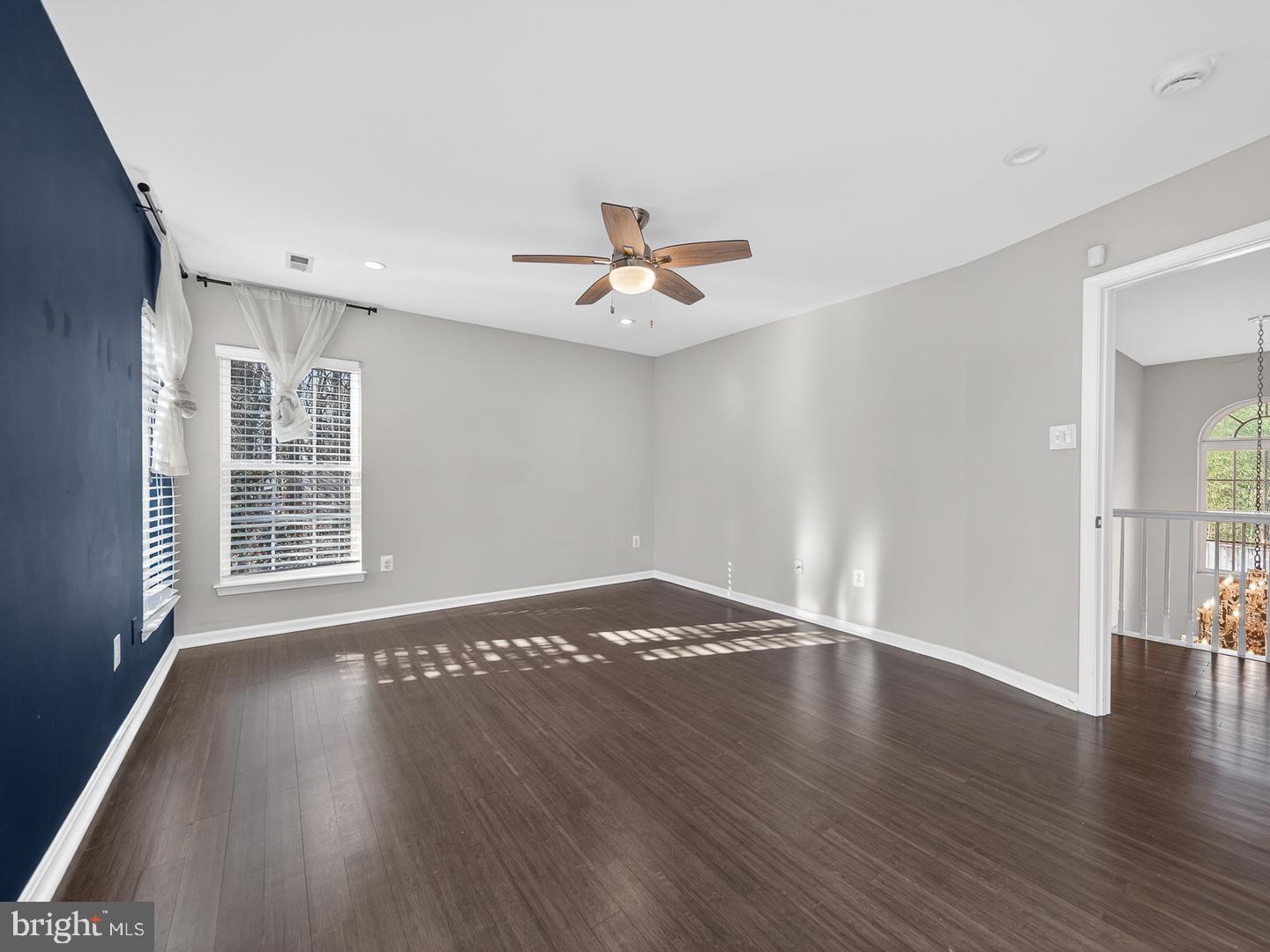 9534 Fernwood Road Bethesda, MD 20817 - Photo 22 of 44 a view of an empty room with wooden floor and a window