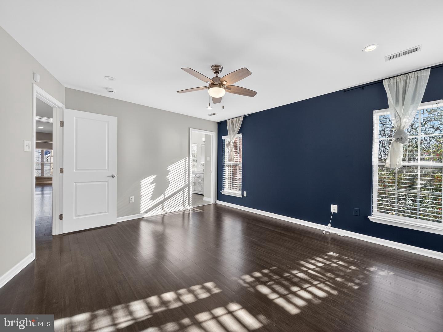 9534 Fernwood Road Bethesda, MD 20817 - Photo 23 of 44 a view of an empty room with a window and wooden floor