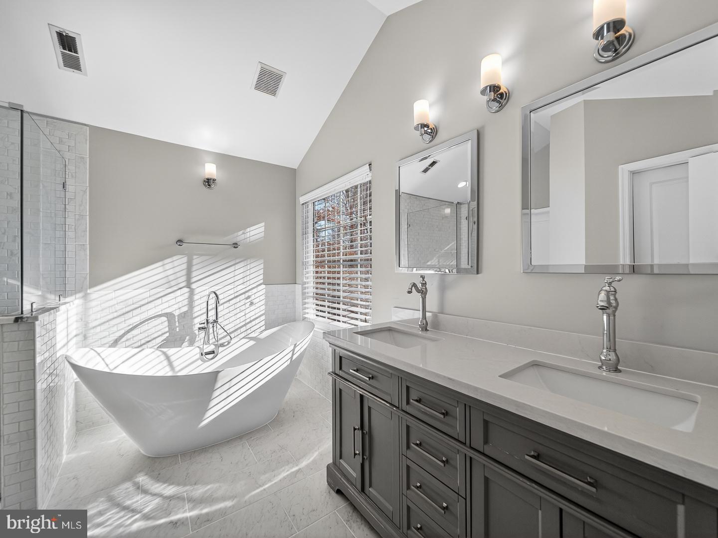 9534 Fernwood Road Bethesda, MD 20817 - Photo 24 of 44 a bathroom with a bathtub and double sink