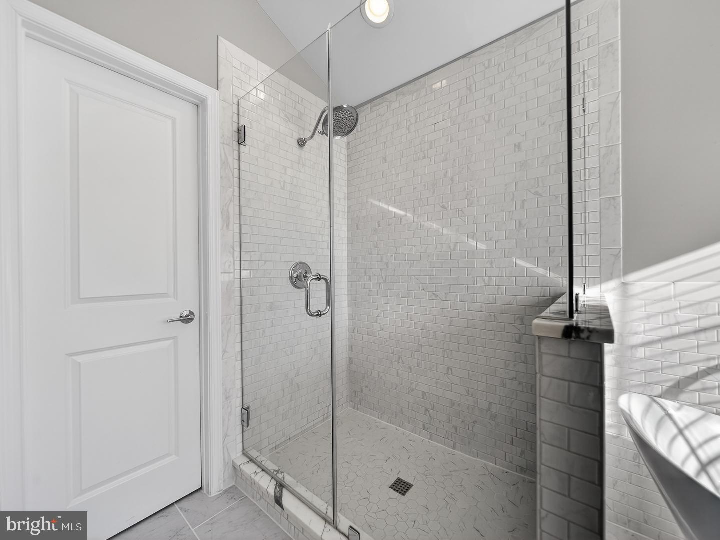 9534 Fernwood Road Bethesda, MD 20817 - Photo 27 of 44 a bathroom with a glass shower door
