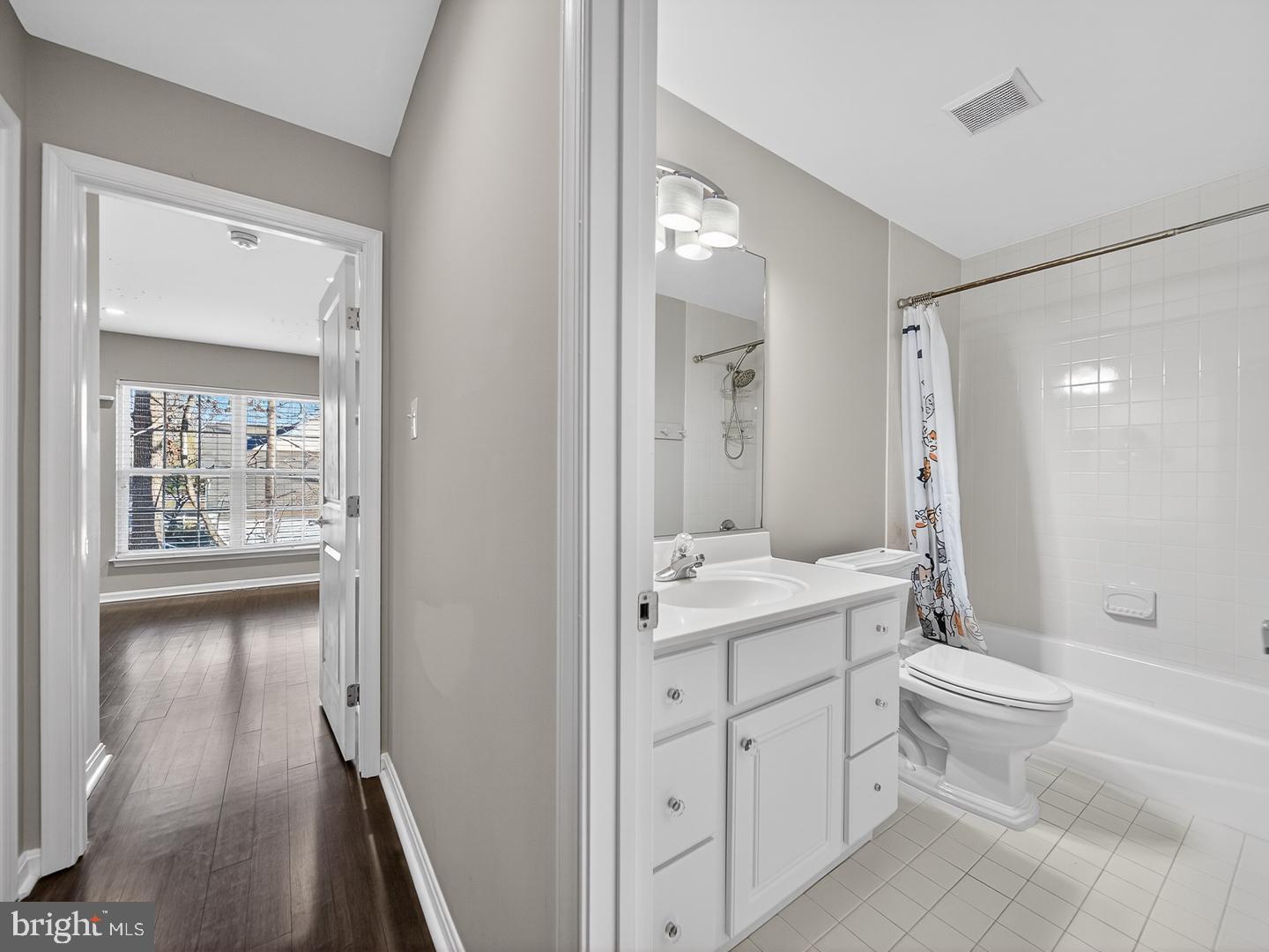 9534 Fernwood Road Bethesda, MD 20817 - Photo 28 of 44 a bathroom with a double vanity sink toilet mirror and bathtub