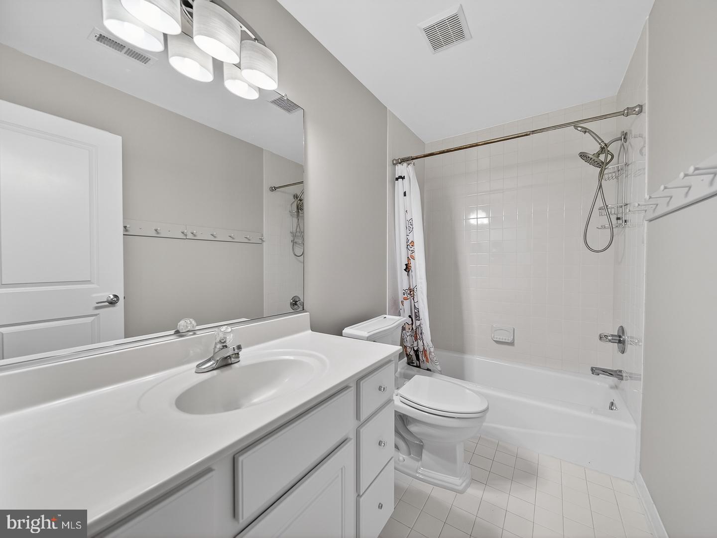 9534 Fernwood Road Bethesda, MD 20817 - Photo 29 of 44 a bathroom with a sink a toilet and a large mirror