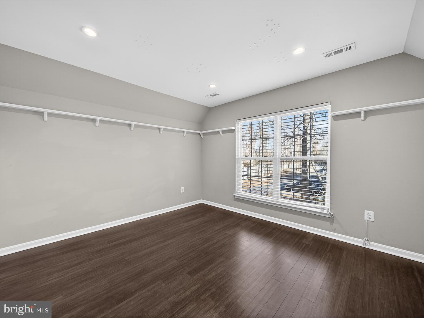 9534 Fernwood Road Bethesda, MD 20817 - Photo 30 of 44 a view of an empty room with wooden floor and a window