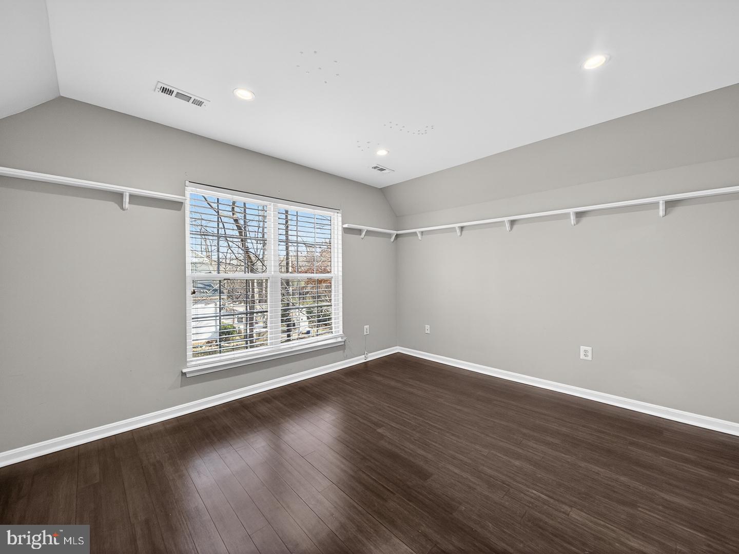 9534 Fernwood Road Bethesda, MD 20817 - Photo 31 of 44 a view of an empty room with wooden floor and a window