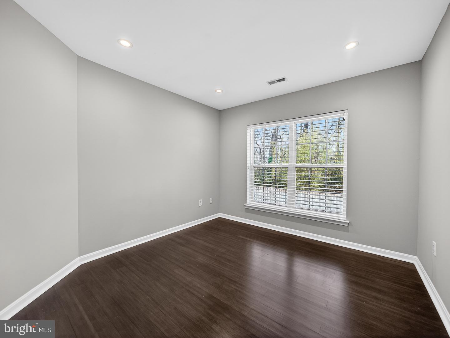 9534 Fernwood Road Bethesda, MD 20817 - Photo 34 of 44 a view of empty room with wooden floor and fan