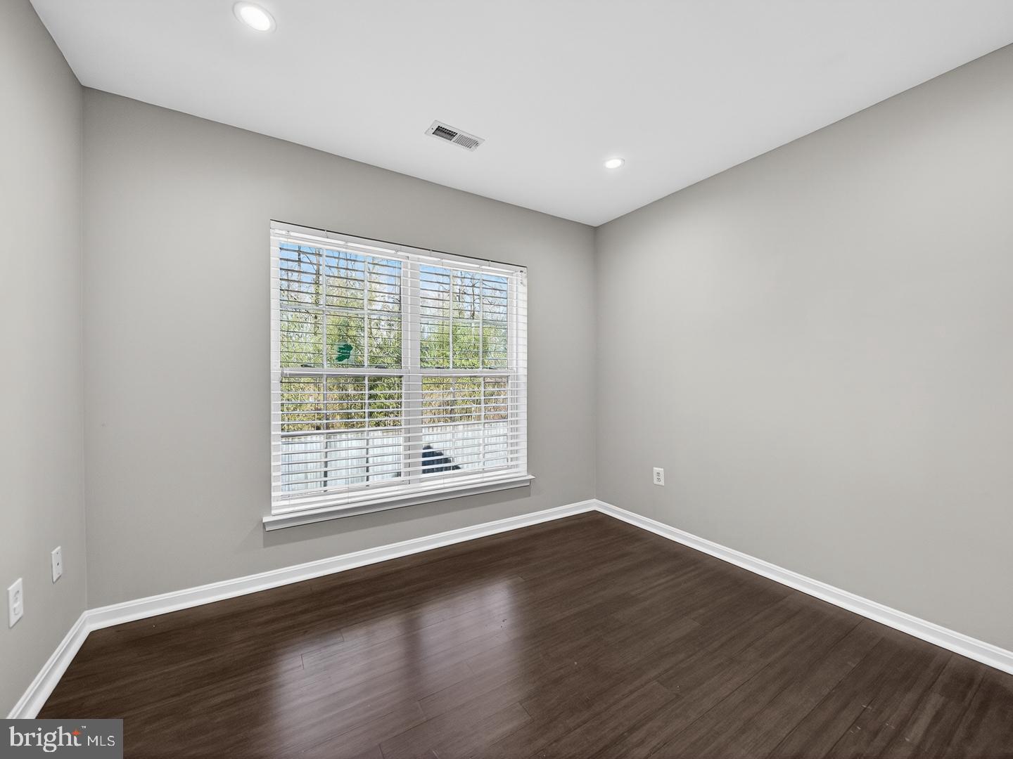 9534 Fernwood Road Bethesda, MD 20817 - Photo 35 of 44 a view of an empty room with wooden floor and a window
