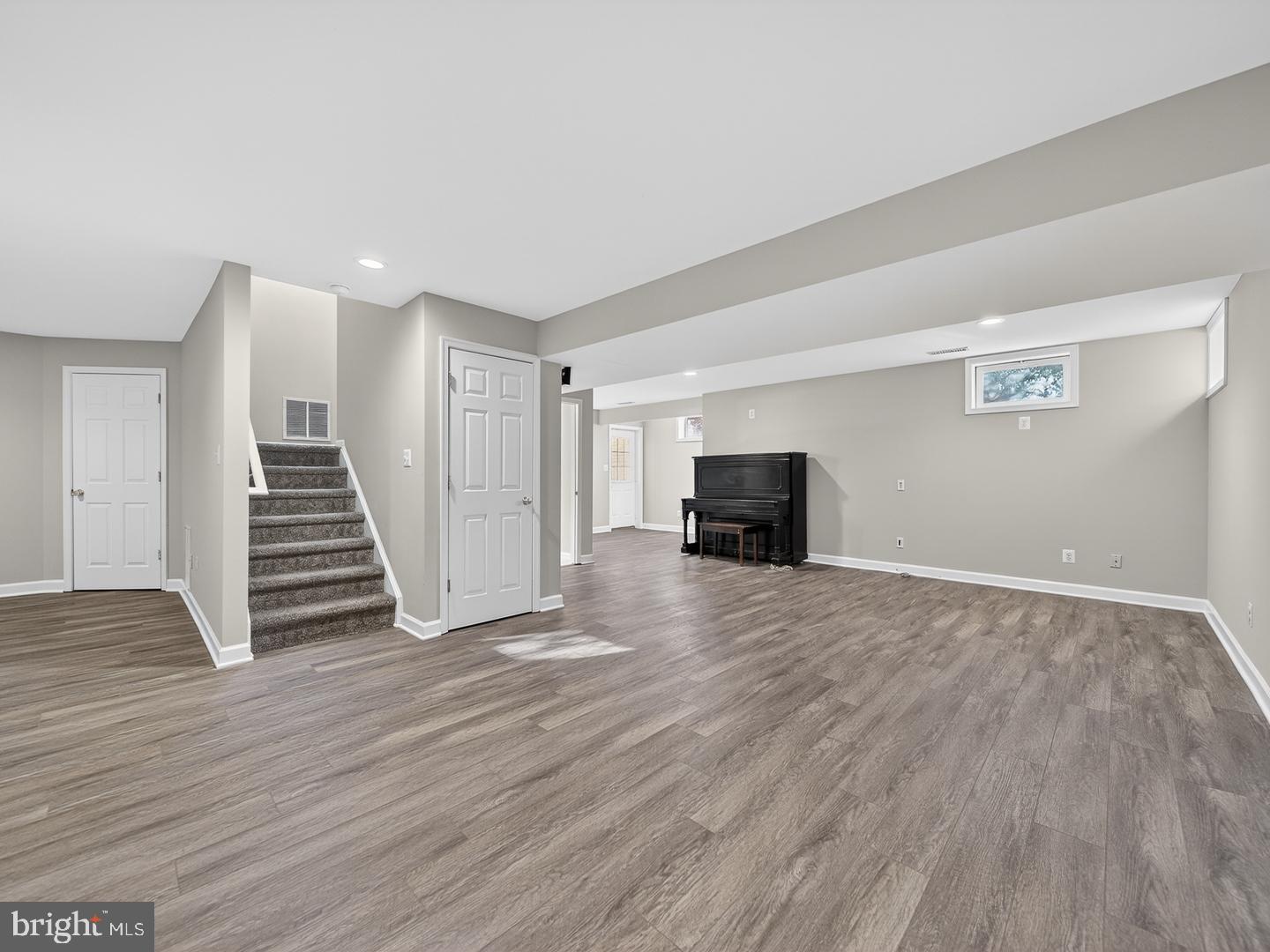 9534 Fernwood Road Bethesda, MD 20817 - Photo 37 of 44 a view of empty room with wooden floor and stairs