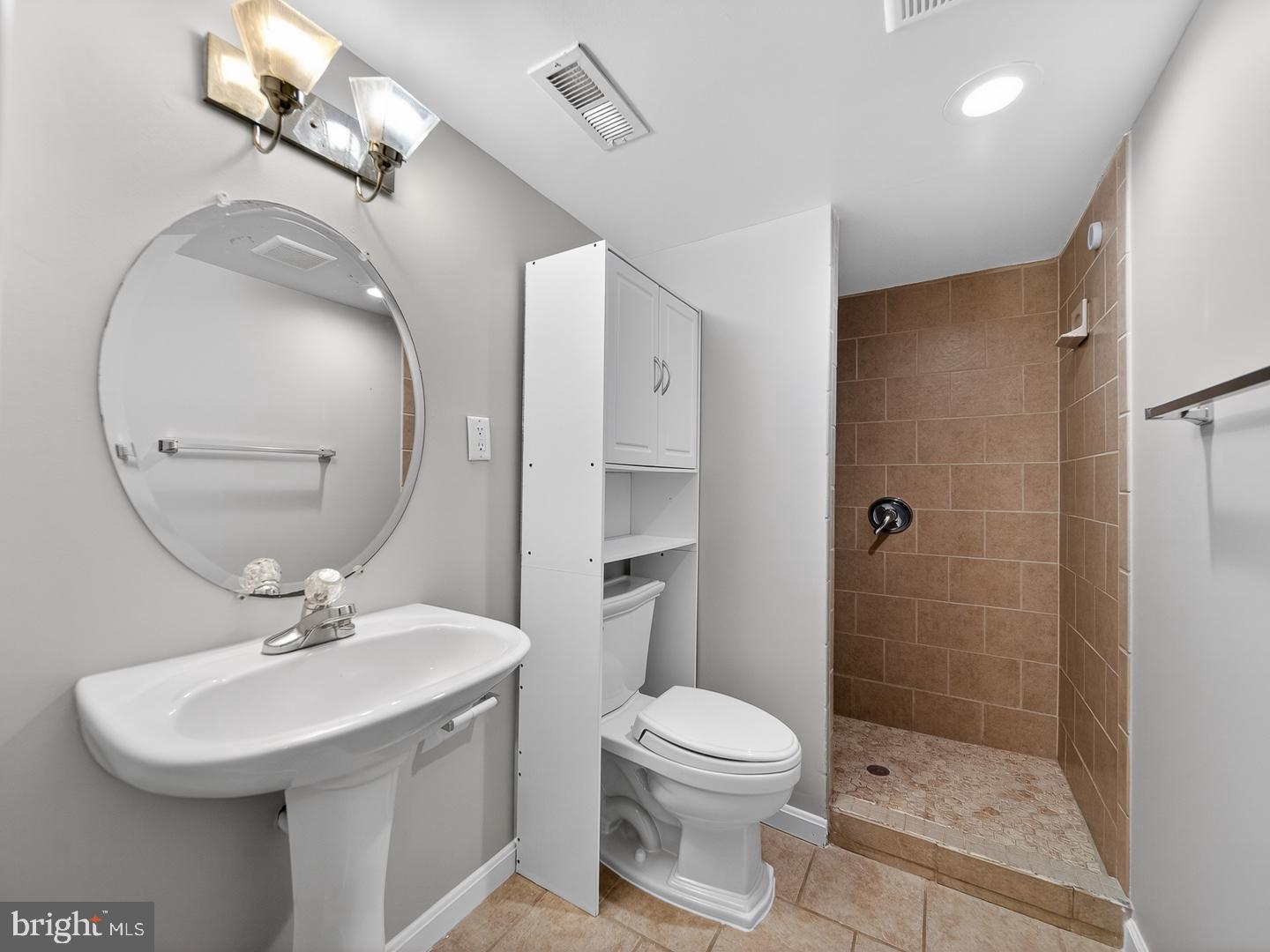 9534 Fernwood Road Bethesda, MD 20817 - Photo 39 of 44 a bathroom with a sink a toilet and shower