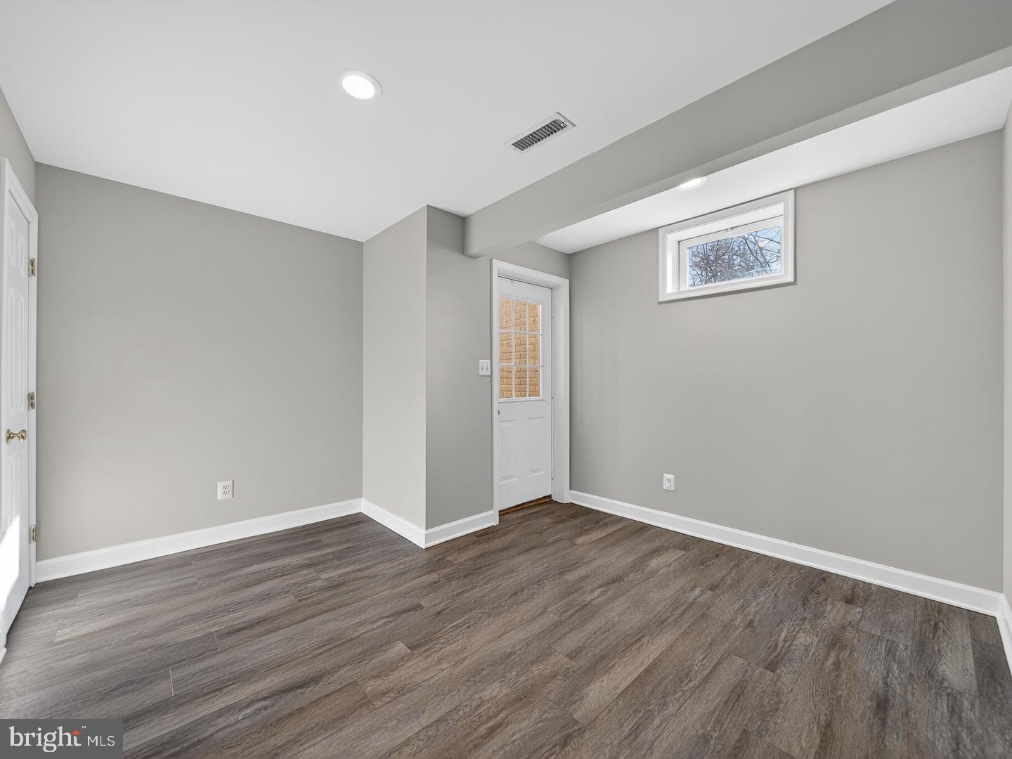 9534 Fernwood Road Bethesda, MD 20817 - Photo 40 of 44 a view of an empty room with wooden floor