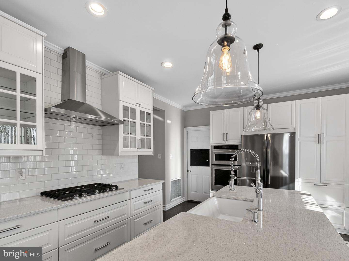 9534 Fernwood Road Bethesda, MD 20817 - Photo 4 of 44 a kitchen with stainless steel appliances kitchen island granite countertop a stove and a refrigerator