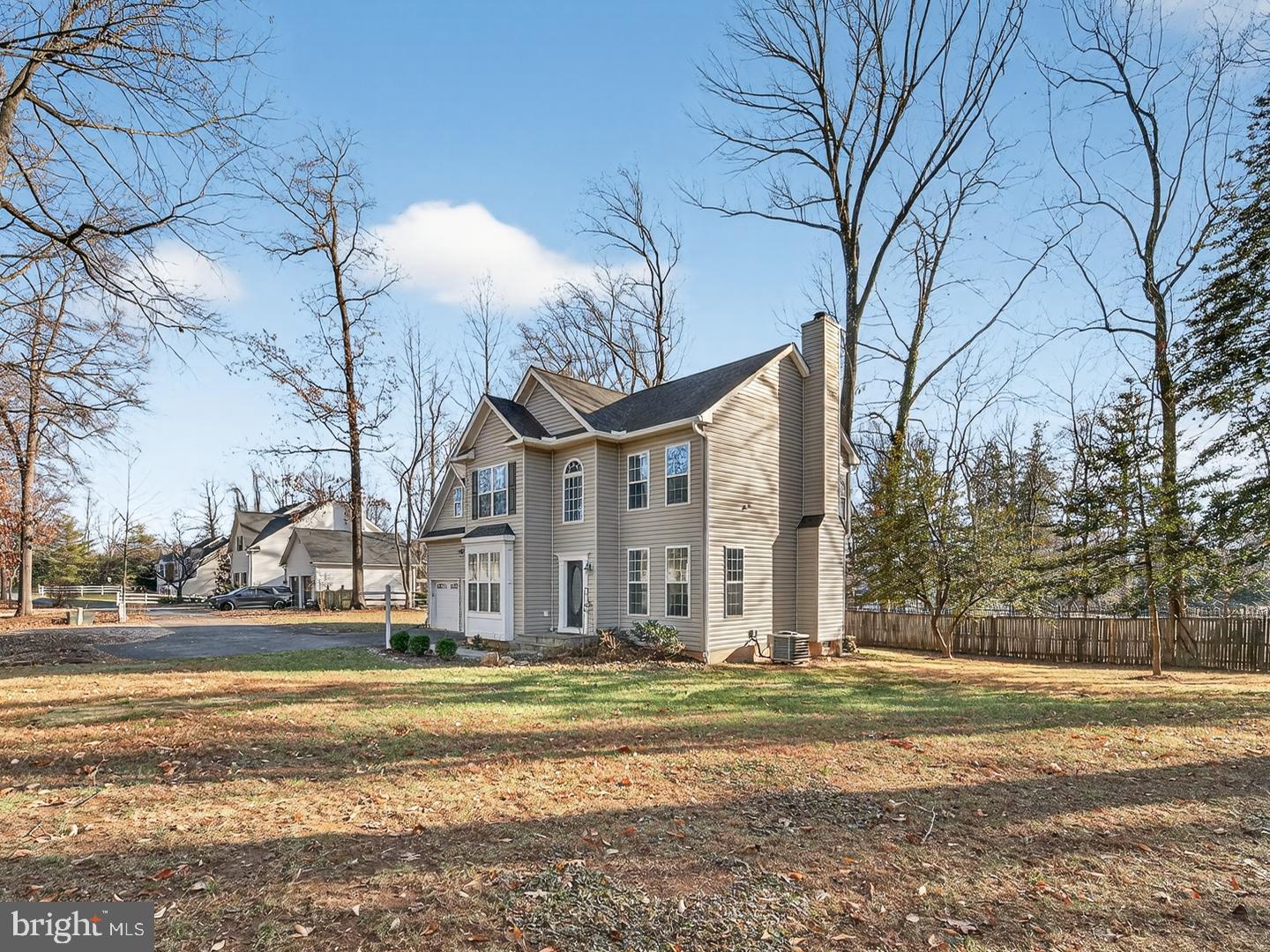 9534 Fernwood Road Bethesda, MD 20817 - Photo 43 of 44 a view of a house with a yard and large trees