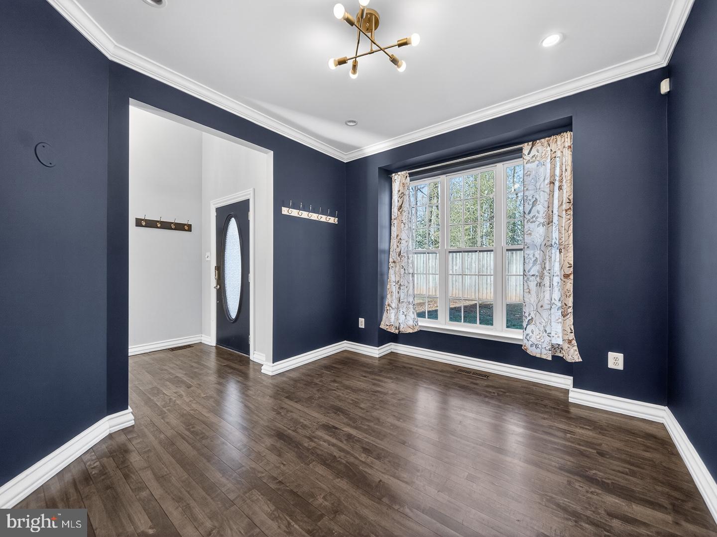 9534 Fernwood Road Bethesda, MD 20817 - Photo 8 of 44 a view of an empty room with wooden floor and a window