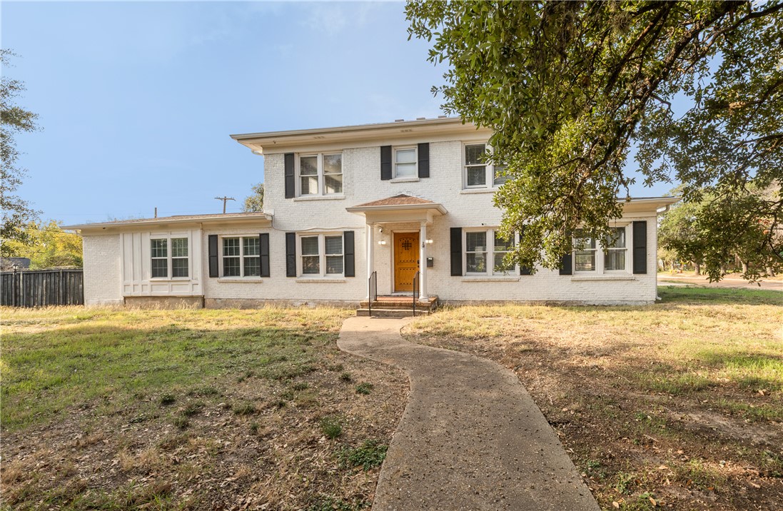 800 South Ennis Street Bryan, TX 77803 - Photo 1 of 38 a front view of a house with a garden