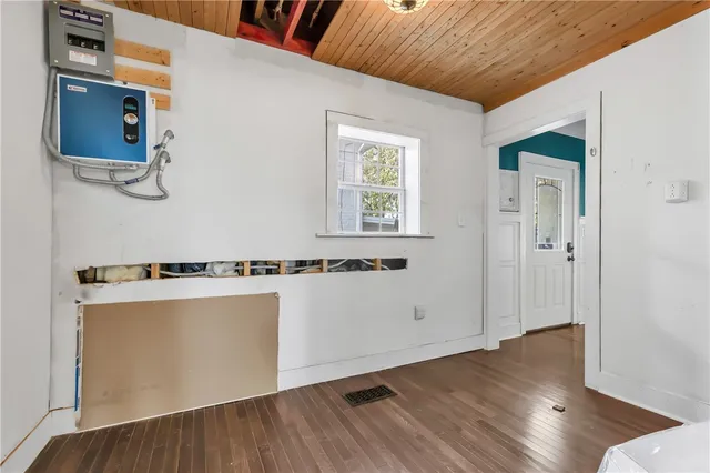 a view of a room with wooden floor and white walls