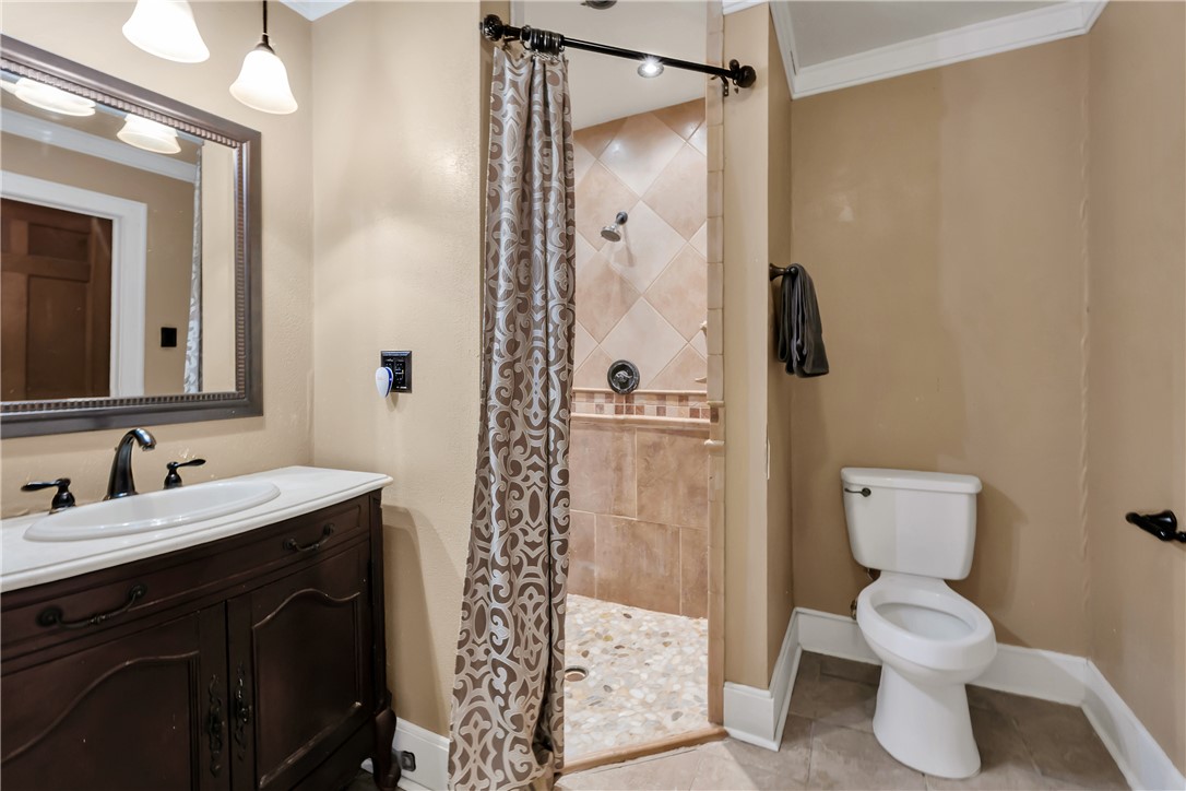 800 South Ennis Street Bryan, TX 77803 - Photo 17 of 38 a bathroom with a toilet sink and shower