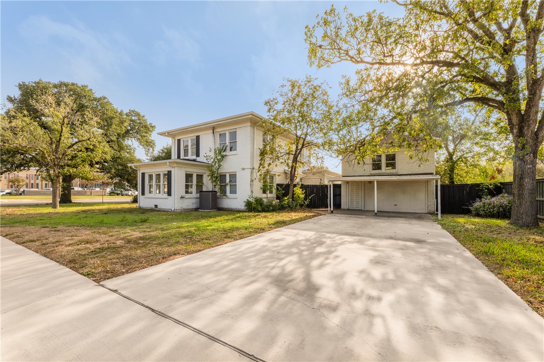 800 South Ennis Street Bryan, TX 77803 - Photo 2 of 38 a front view of a house with a yard and trees