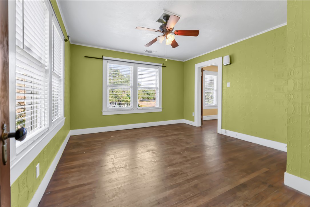 800 South Ennis Street Bryan, TX 77803 - Photo 23 of 38 a view of an empty room with a window and wooden floor