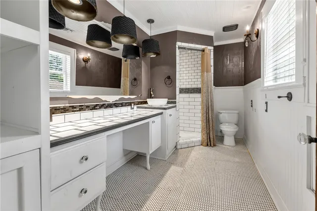 a bathroom with a sink a toilet and mirror