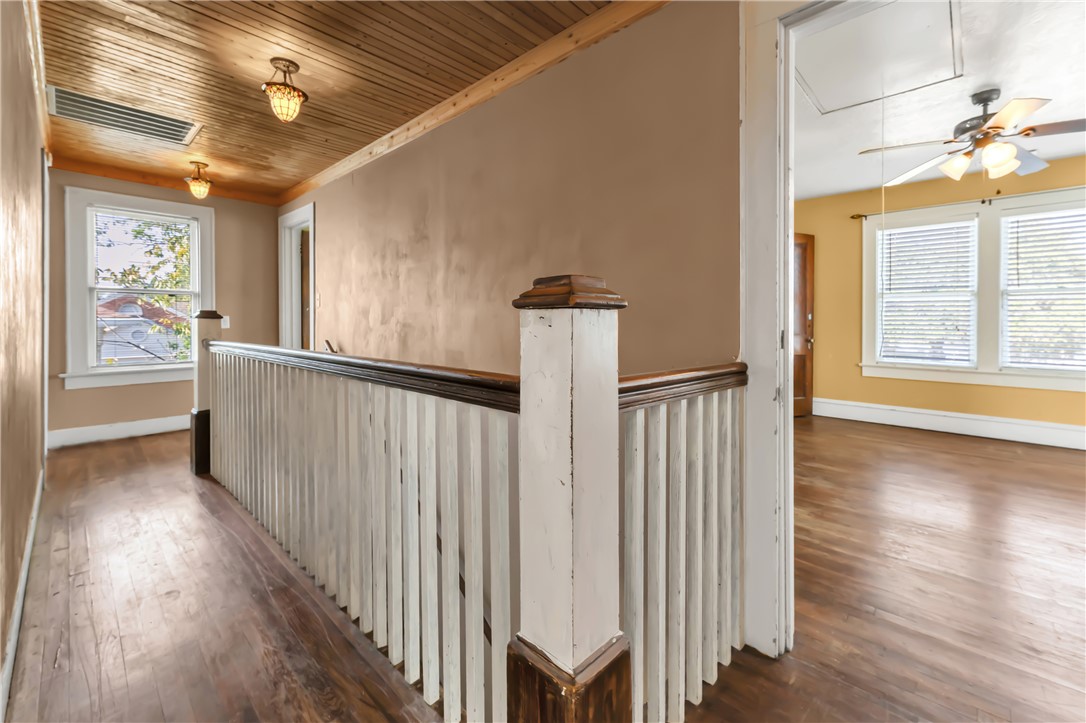 800 South Ennis Street Bryan, TX 77803 - Photo 25 of 38 a view of a hallway with wooden floor and a chandelier