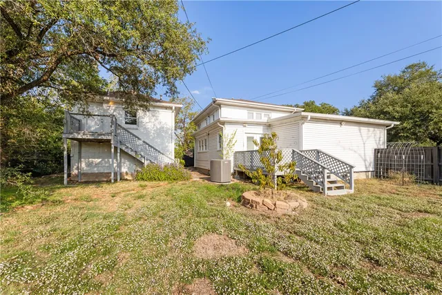 a backyard of a house with table and chairs