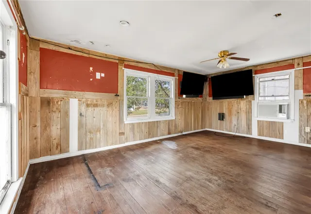 a view of a livingroom with an empty space and a window