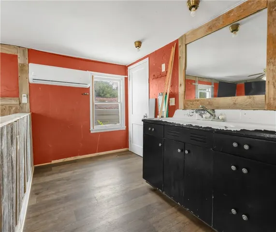 a bathroom with a sink vanity and a mirror