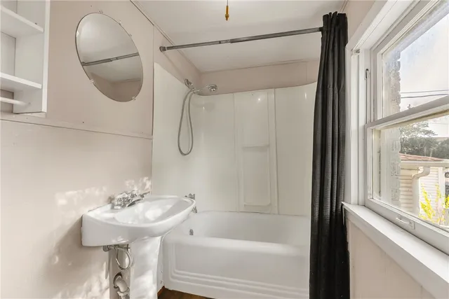 a bathroom with a sink a glass door and shower