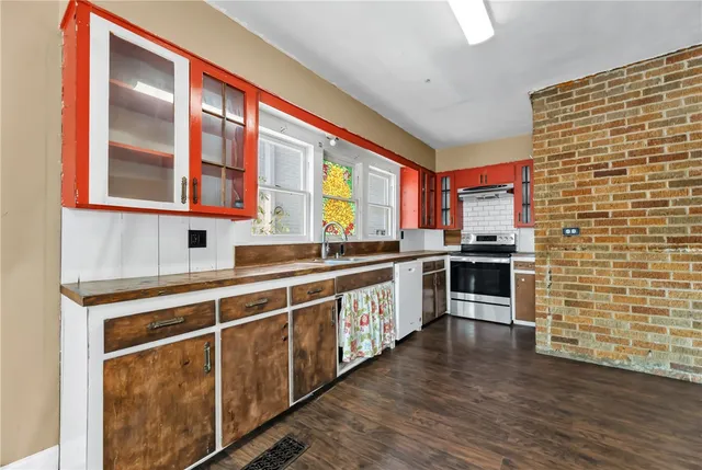 a kitchen with stainless steel appliances a sink and cabinets