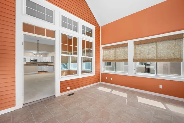 a living room with furniture a flat screen tv and a window