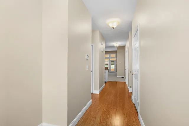 a view of a hallway with wooden floor