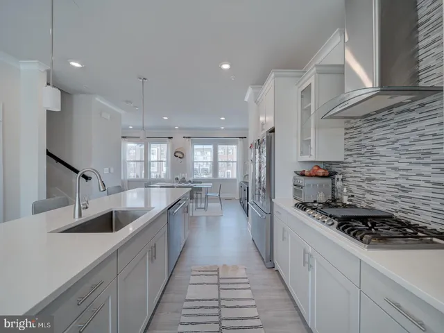 a kitchen with sink stove and refrigerator