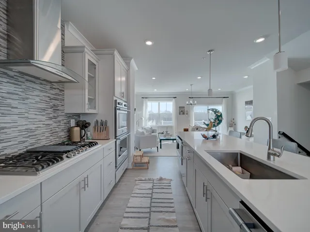a kitchen with stainless steel appliances a sink stove and cabinets