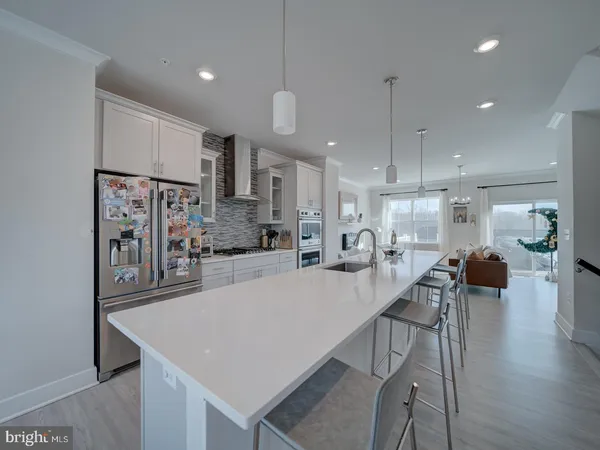 a large kitchen with a table and chairs
