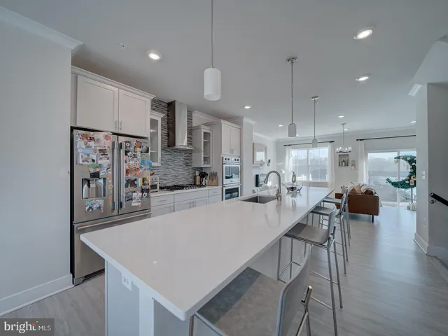 a large kitchen with a table and chairs
