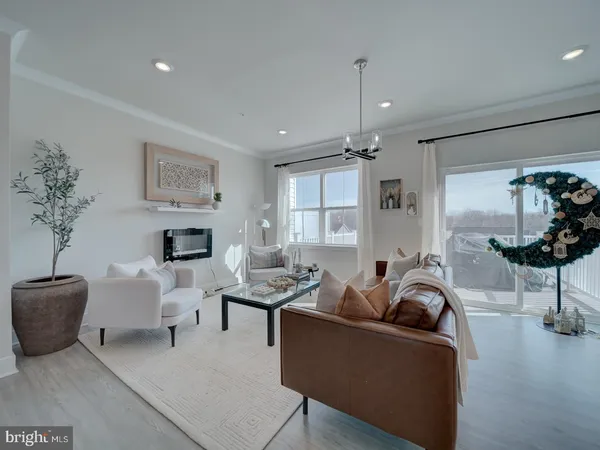 a living room with furniture a chandelier and a flat screen tv