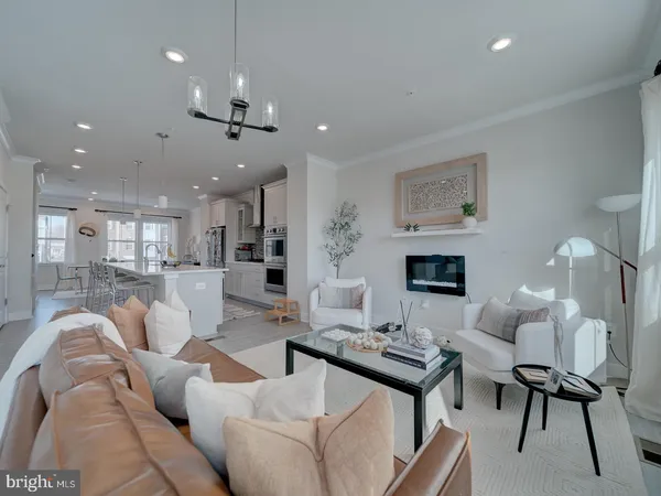 a living room with furniture a fireplace and a chandelier