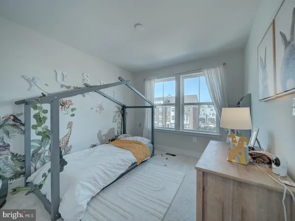 a bedroom with a bed and a large window