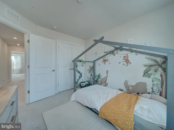 a bedroom with a bed and a mirror