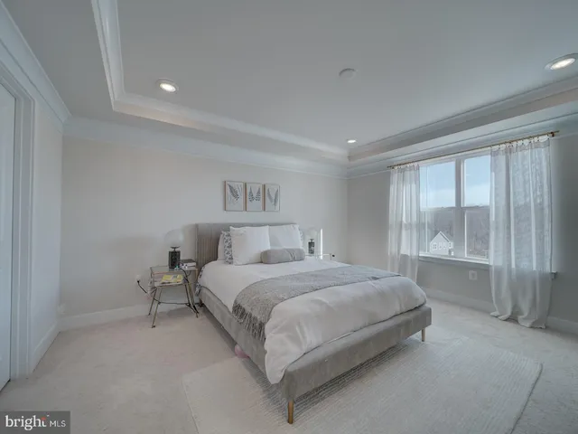 a bedroom with a bed and large window